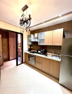 a large kitchen with a bicycle hanging from the ceiling at L'Escapade Douce Marrakech in Marrakech