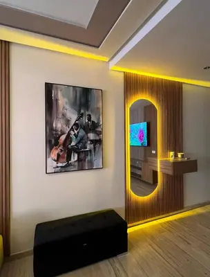 a living room with a television and a mirror at L'Escapade Douce Marrakech in Marrakech