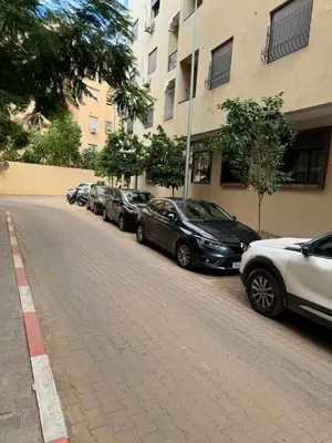 a row of cars parked on the side of a street at Appartement N15 Lumineux Calme & Centre-ville in Marrakech