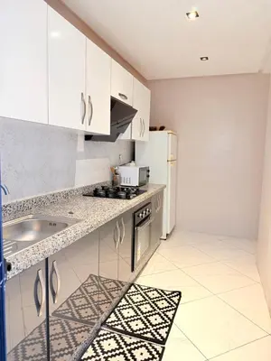 a kitchen with white cabinets and a sink at Appartement N15 Lumineux Calme & Centre-ville in Marrakech