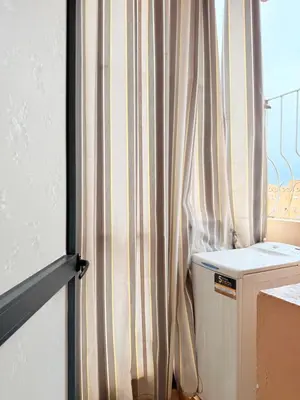 a bathroom with a shower curtain next to a window at Appartement N15 Lumineux Calme & Centre-ville in Marrakech