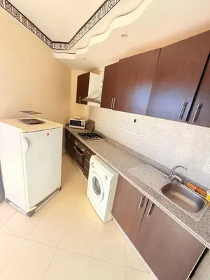 a kitchen with a sink and a washer and dryer at D13 Confortable A Riad Jawhara & Piscines in Marrakech