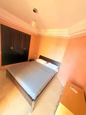 a bedroom with a bed and a black cabinet at D13 Confortable A Riad Jawhara & Piscines in Marrakech