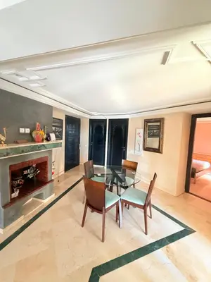 a dining room with a glass table and chairs at D13 Confortable A Riad Jawhara & Piscines in Marrakech