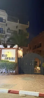 a building with a sign that reads rafi zawaza at D13 Confortable A Riad Jawhara & Piscines in Marrakech