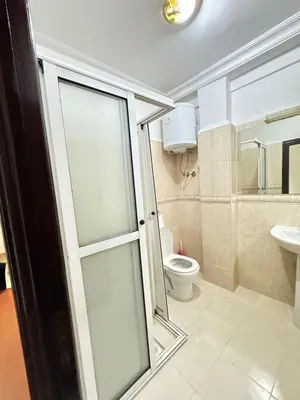 a bathroom with a toilet and a glass door at le numéro 7 in Marrakech