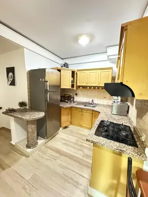 a kitchen with wooden cabinets and stainless steel appliances at le numéro 7 in Marrakech