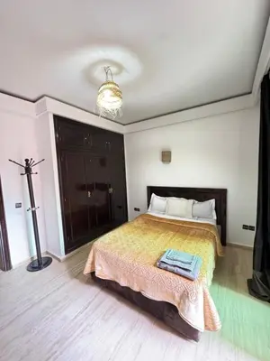 a bedroom with a bed and a chandelier at le numéro 7 in Marrakech