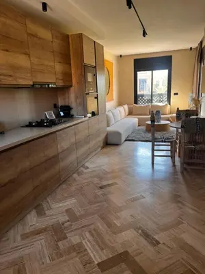 a kitchen and living room with a couch and a table at Your Getaway Oasis in the Lush Resort in Marrakech