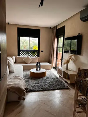 a living room with a couch and a table at Your Getaway Oasis in the Lush Resort in Marrakech