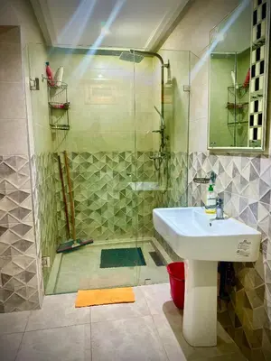 a bathroom with a shower and a white sink at المحاميد 10 in Marrakech