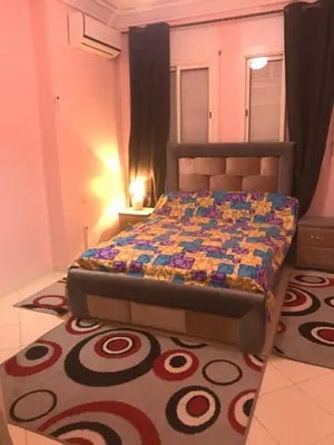 a bedroom with a bed with a colorful quilt on it at Appartement Simouni in Marrakech