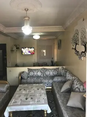 a living room with a couch and a table at Appartement Simouni in Marrakech