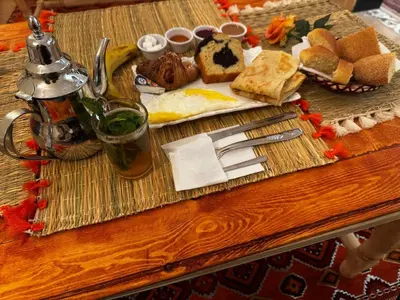 a table with a tray of breakfast foods on it at Riad dar Malak in Marrakech