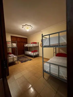 a room with three bunk beds in a room at Riad dar Malak in Marrakech