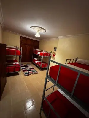 a room with three bunk beds and a room with a room at Riad dar Malak in Marrakech