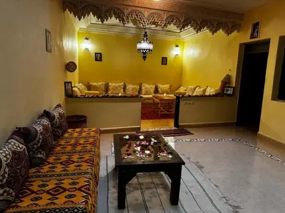 a living room with a couch and a table at Riad dar Malak in Marrakech