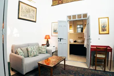 a living room with a couch and a table at Riad Dar Dounia in Marrakech