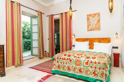 a bedroom with a bed with a colorful bedspread at Riad Dar Dounia in Marrakech