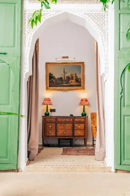 a room with a dresser and a painting on the wall at Riad Dar Dounia in Marrakech