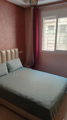 a large bed in a room with a window at Mountazah al jadid H22 in Marrakech