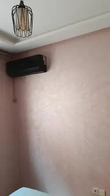 a room with a fan on a wall at Mountazah al jadid H22 in Marrakech