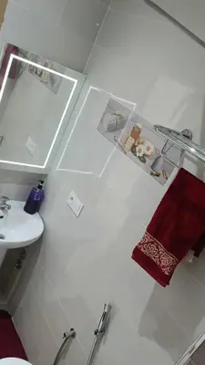 a white bathroom with a sink and a toilet and a sink at Mountazah al jadid H22 in Marrakech