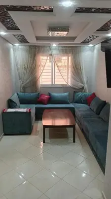 a living room with a couch and a table at Mountazah al jadid H22 in Marrakech