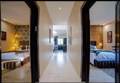 a view of a bedroom with two beds and a mirror at villa abraj in Marrakech