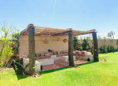 a pergola with a couch in a yard at villa abraj in Marrakech