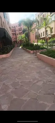 a stone walk way in a city with buildings at Premium village A644 in Marrakech