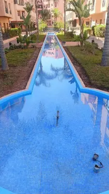a large blue swimming pool in a resort at Premium village A644 in Marrakech