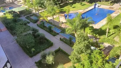 an overhead view of a pool with trees and bushes at Premium village A644 in Marrakech