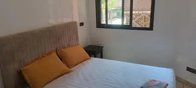 a bedroom with a bed with white sheets and a window at Premium village A644 in Marrakech