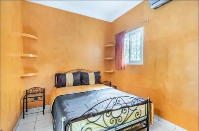 a bedroom with a bed and a window at Riad Golden Palm in Marrakech