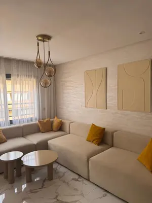 a living room with a couch and a table at Apartment JADE Palmeraie, residence with pool in Marrakech