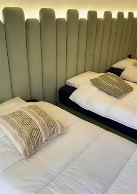 two beds with pillows on them in a room at Apartment JADE Palmeraie, residence with pool in Marrakech