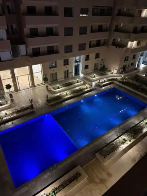 an overhead view of a large swimming pool in a building at Apartment JADE Palmeraie, residence with pool in Marrakech