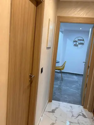 a door leading into a room with a marble floor at Apartment JADE Palmeraie, residence with pool in Marrakech