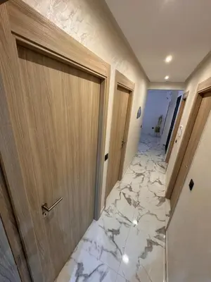 a hallway with a marble floor and a door at Apartment JADE Palmeraie, residence with pool in Marrakech