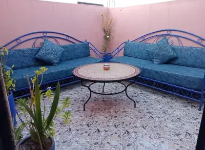 a living room with two blue couches and a table at Apartment in heart of Medina in Marrakech