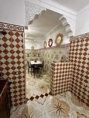 a bathroom with a table and a dining room at Apartment in heart of Medina in Marrakech