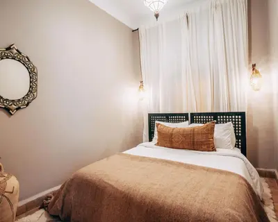 a bedroom with a bed with a large window at Riad Privatif avec Personnel et Services Exclusifs - Kasbah Boma Marrakech I in Marrakech