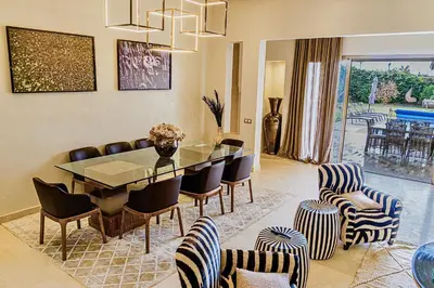 a dining room with a table and chairs at Heated Pool Villa in Marrakech