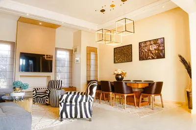 a living room with a table and chairs at Heated Pool Villa in Marrakech
