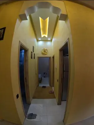 a hallway with a ceiling with a hallway leading into a room at Appartement en résidence in Marrakech