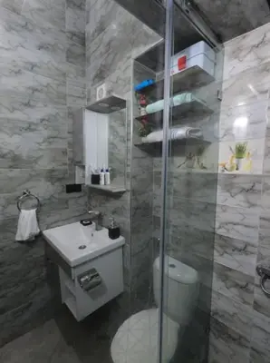 a bathroom with a shower and a toilet and a sink at Appartement en résidence in Marrakech
