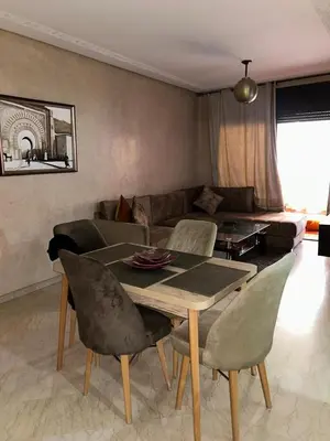 a living room with a table and a couch at Immob in Marrakech