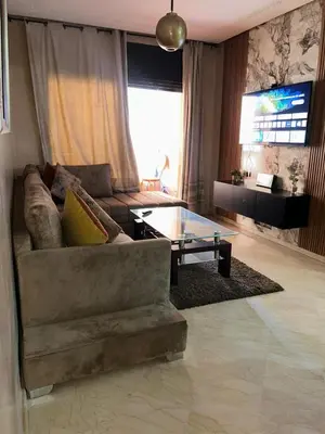 a living room with a couch and a glass table at Immob in Marrakech
