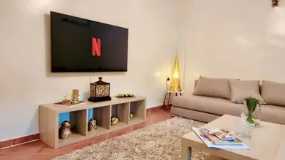 a living room with a couch and a tv at Immob in Marrakech